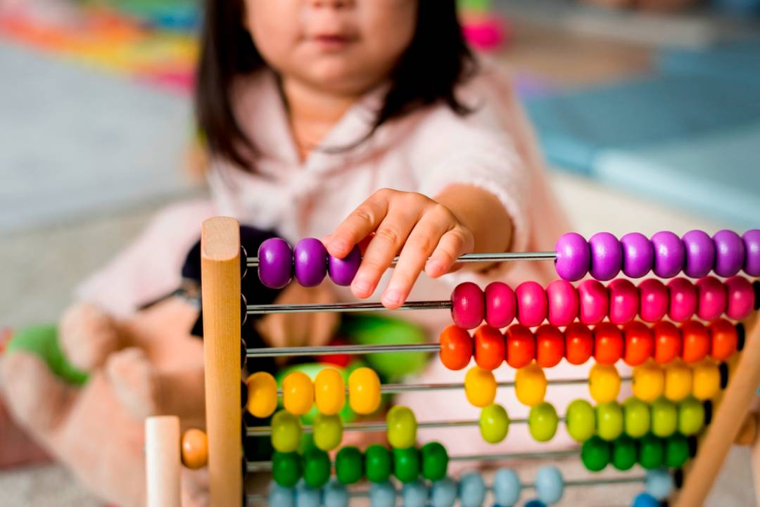 girl playing with abacus