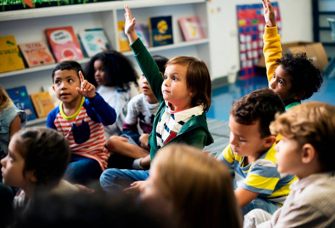 kids raising hands